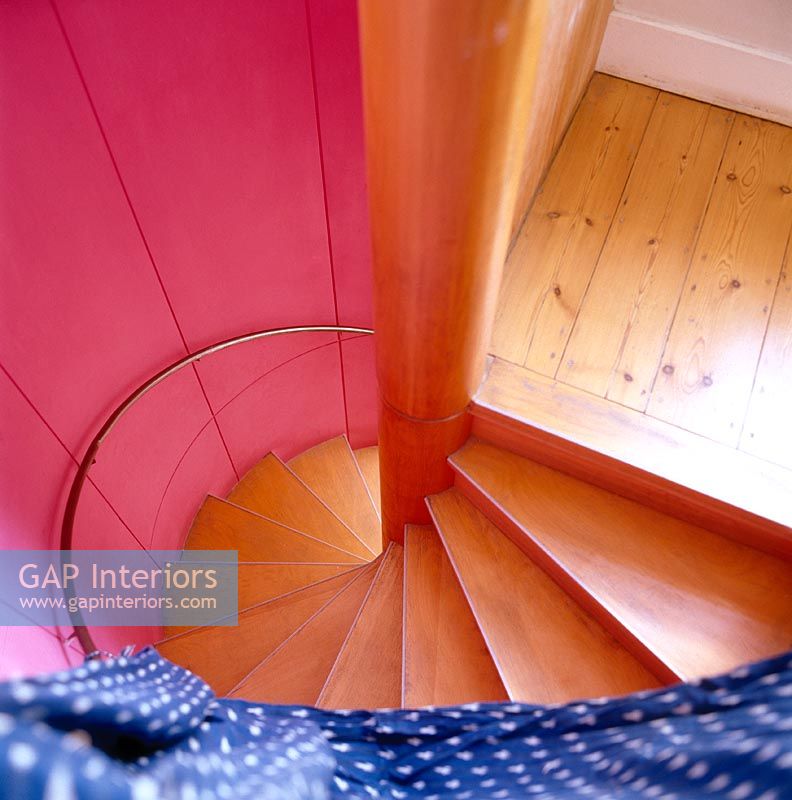 Modern spiral staircase with colourful walls 