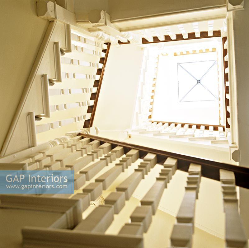 View up classic stairwell to skylight 