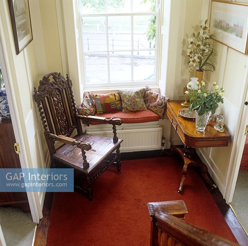 Chair and window seat in classic hallway 