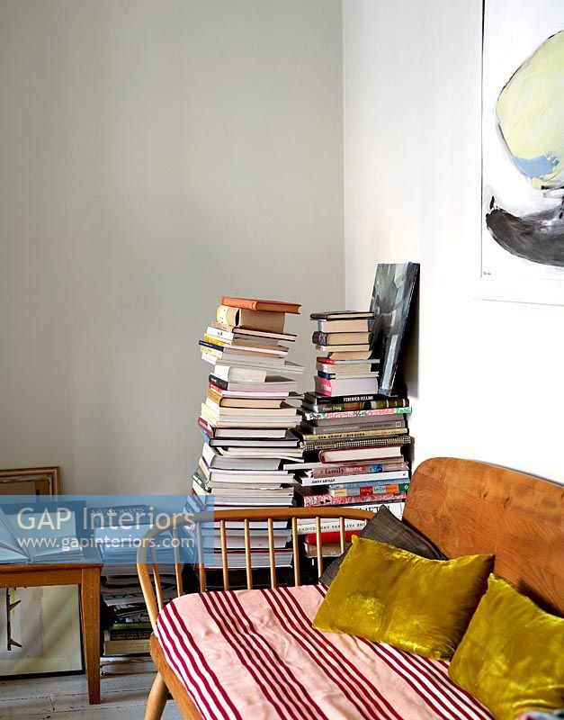 Piles of books in modern living room 