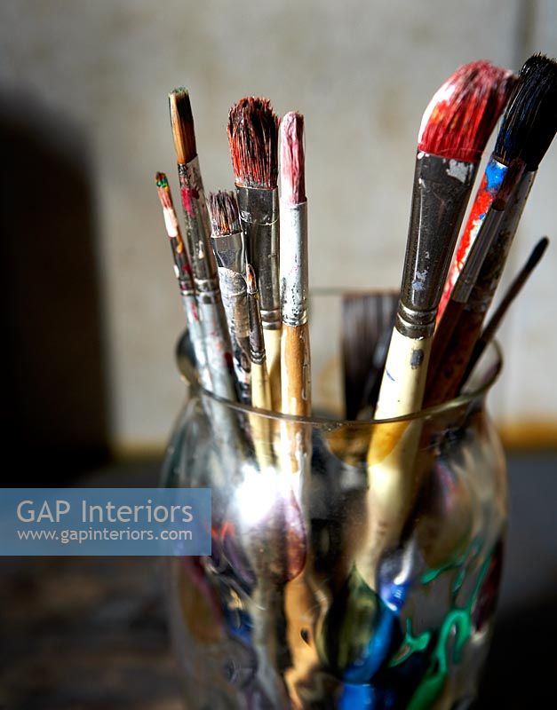 Detail of artists paint brushes in glass 
