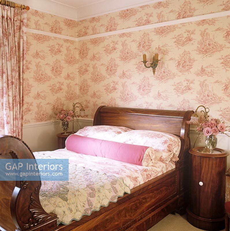 Country bedroom with floral wallpaper 