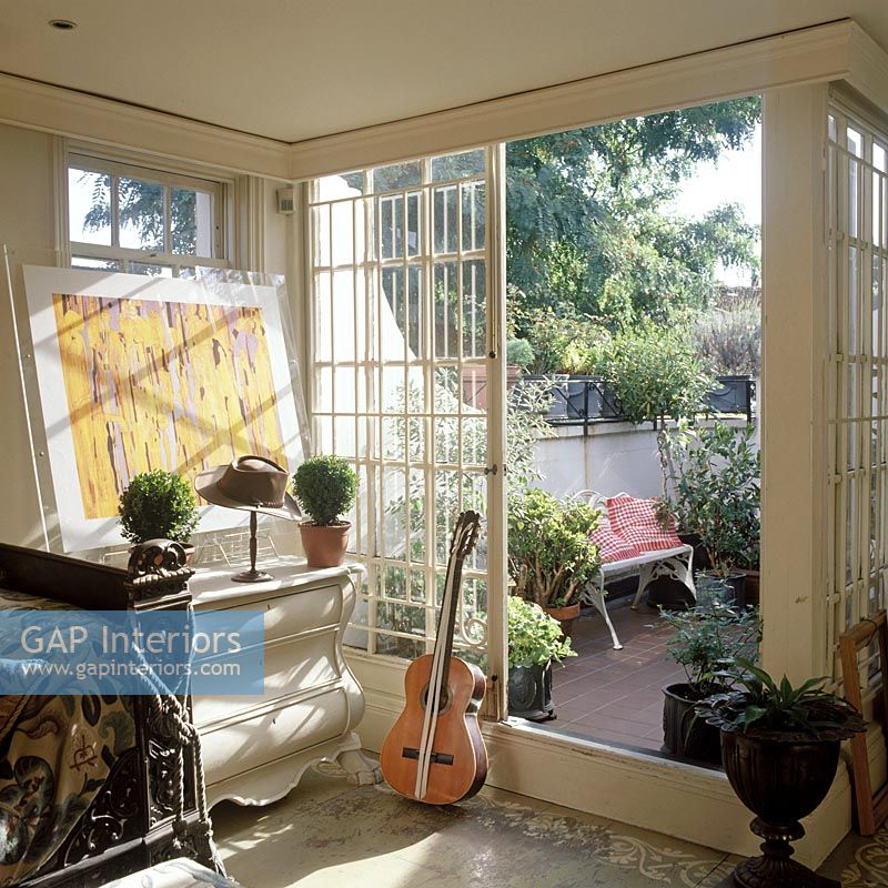 Guitar by french windows in classic living room