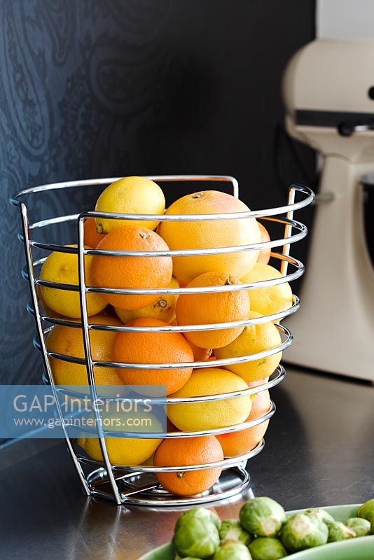 Metal fruit bowl on kitchen worktop 
