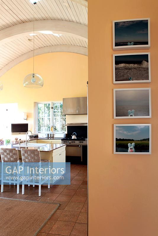 Pictures on wall of modern kitchen 