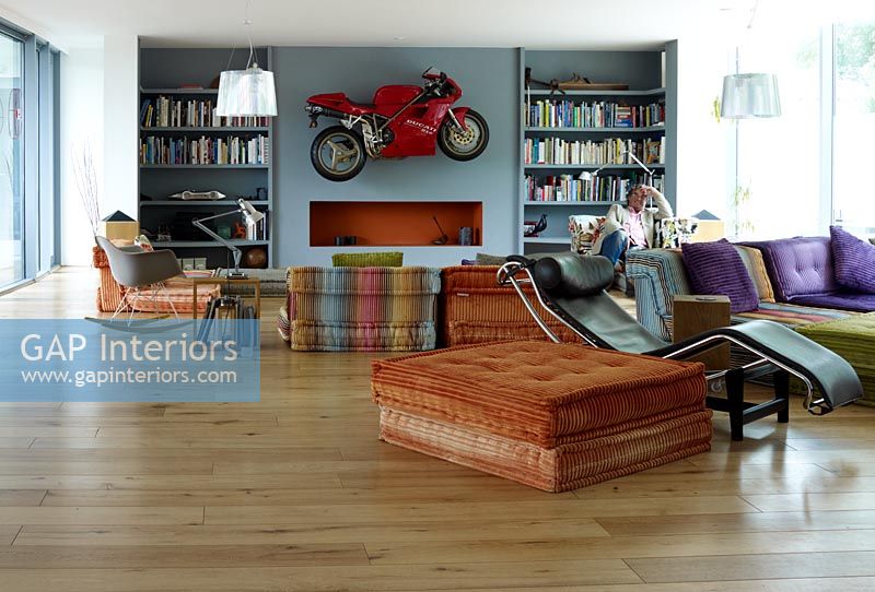 Contemporary living room with motorbike on wall