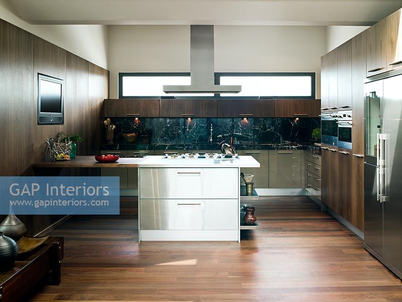 Stainless steel island in modern wooden kitchen