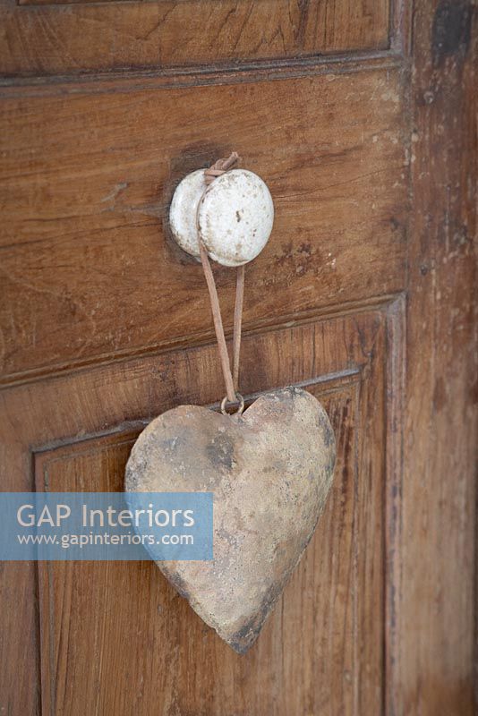 Heart shaped pendant hanging on door knob