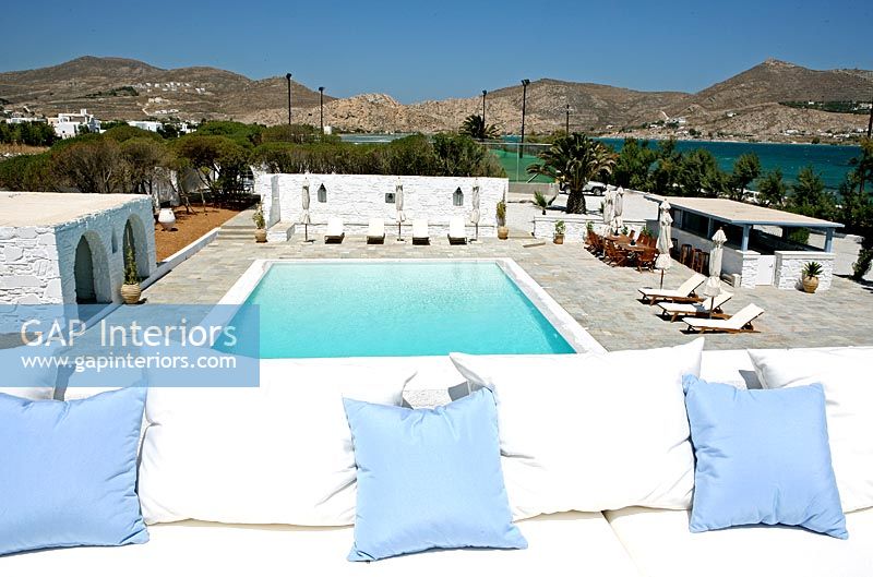 Cushions on seat overlooking swimming pool 