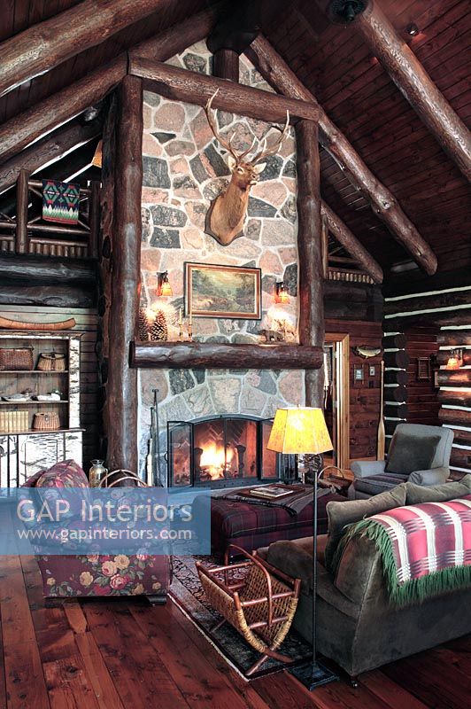 Country log cabin living room with fire 