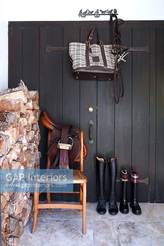 Horse riding equipment in country hallway 