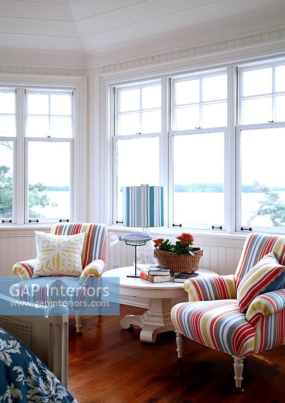 Striped armchairs in country living room 
