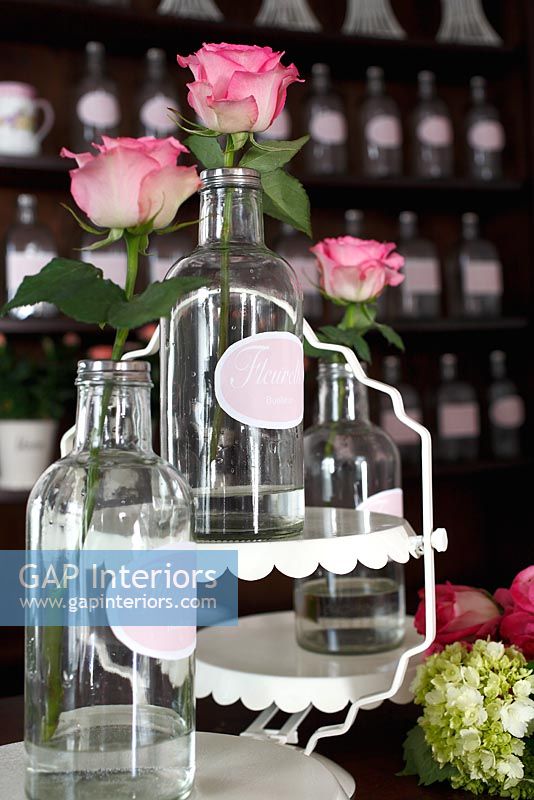 Display of roses in vintage bottles 