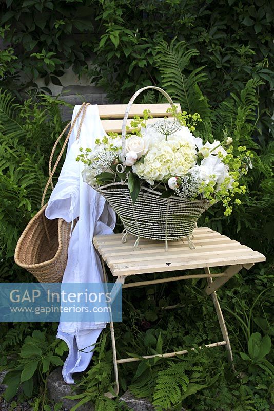 Basket of flowers on vintage chair 