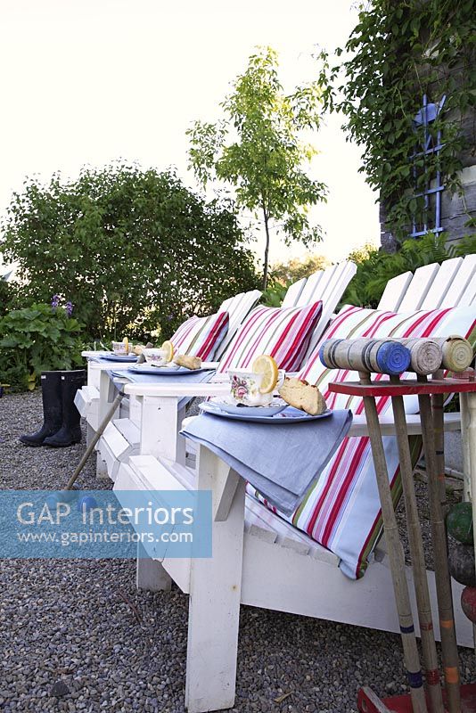 Garden chairs and croquet mallets on terrace 