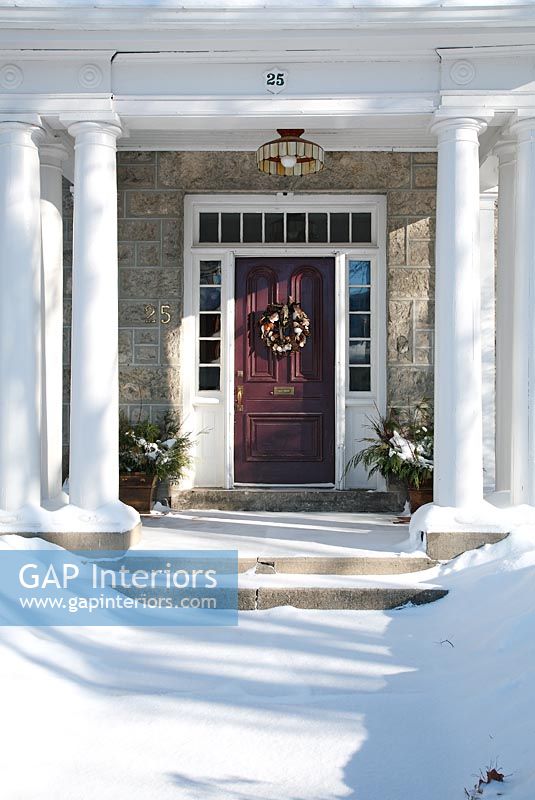 Classic front door and snow covered path