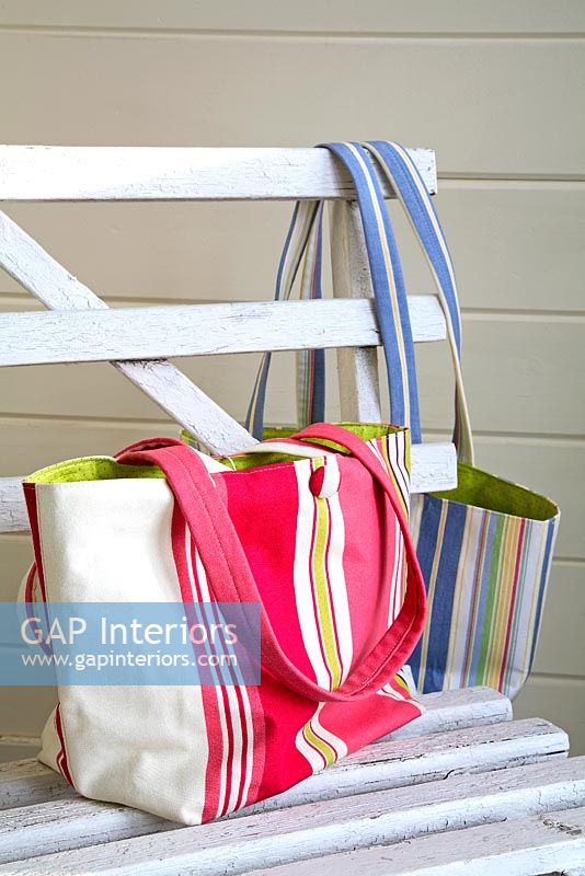 Striped bags on vintage bench 