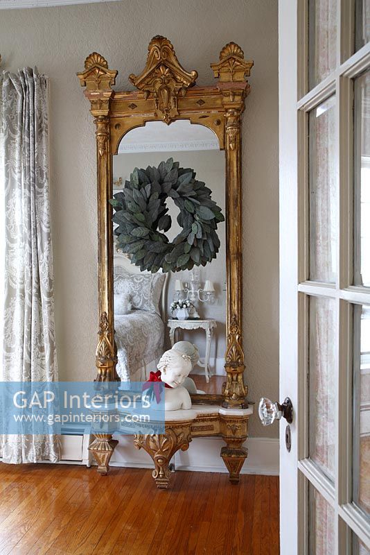 Gilded mirror in classic bedroom