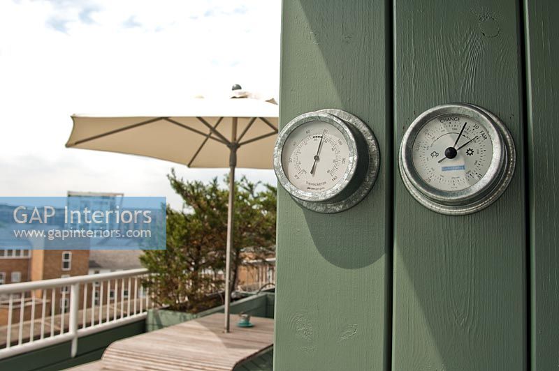 Barometers on garden wall 