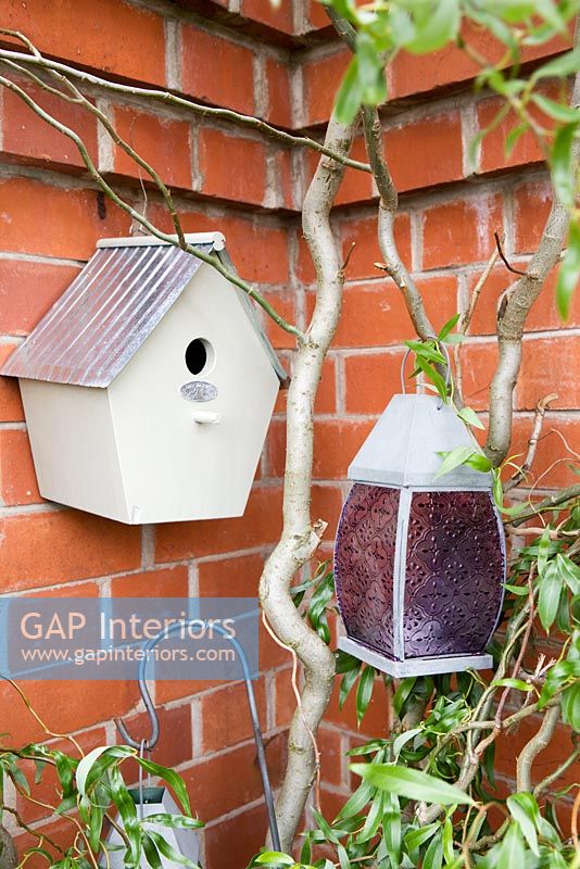 Bird box and lanterns in walled garden 