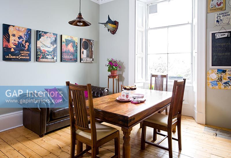 Modern poster artwork in classic dining room 