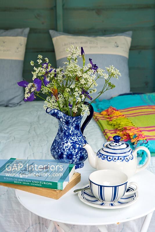 Tea cup and books on side table 