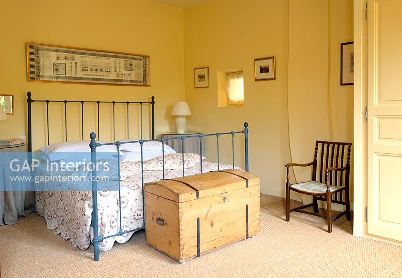 Country bedroom with iron bedstead 