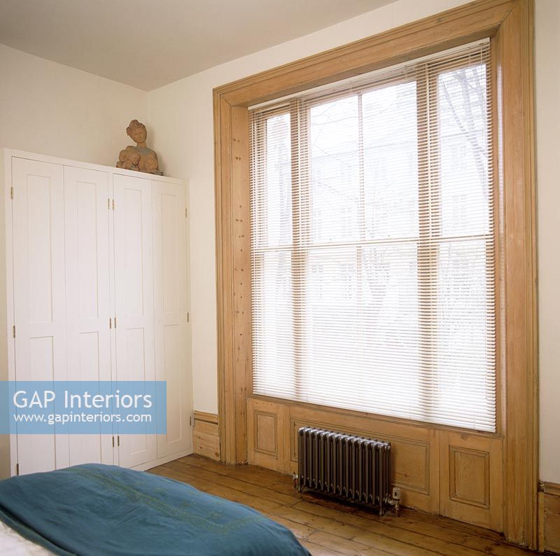 Large window in classic bedroom 