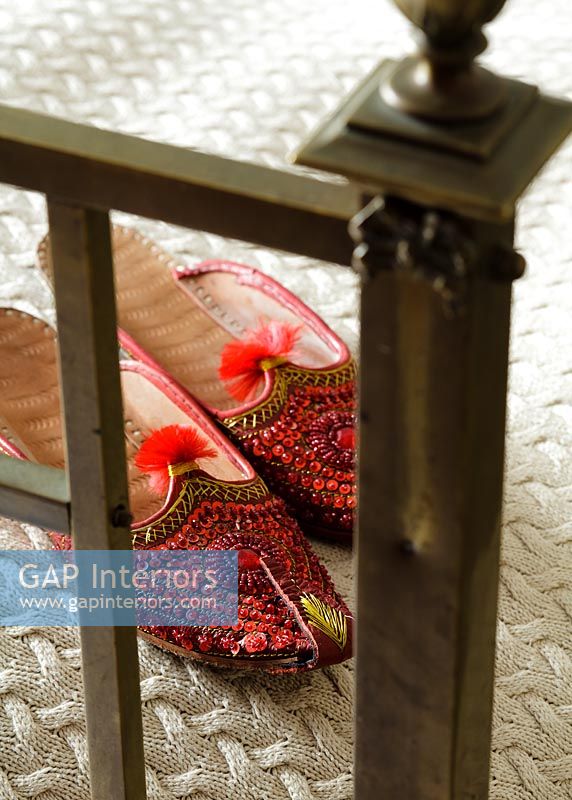 Embroidered Moroccan slippers on bed