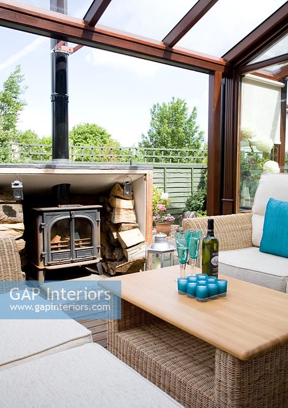 Decked covered patio with sofas and fireplace