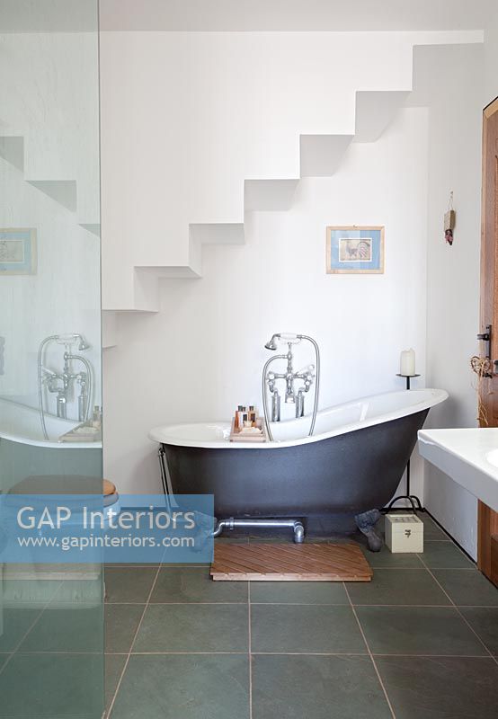 Roll top bath in alcove under stairs