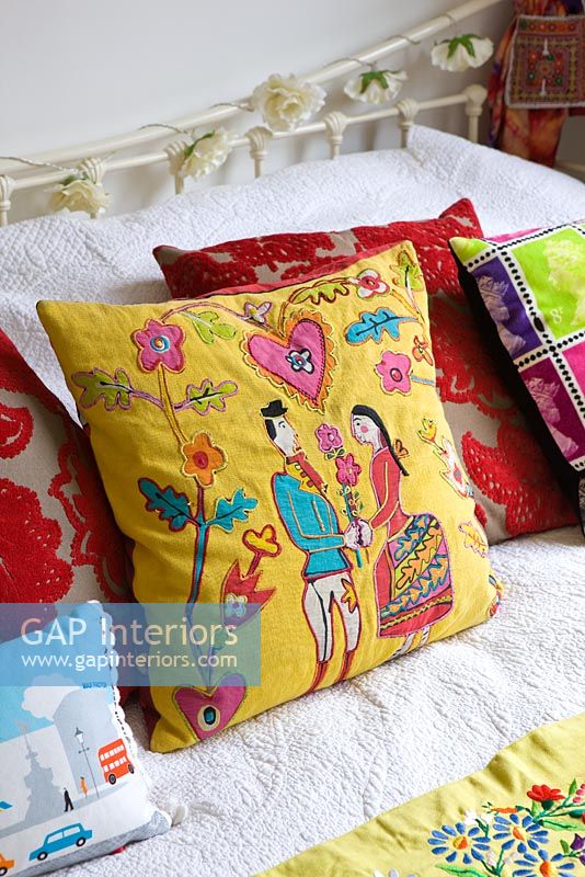 Appliqued cushions on bed