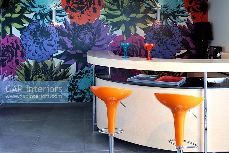 Curved bar with orange stools