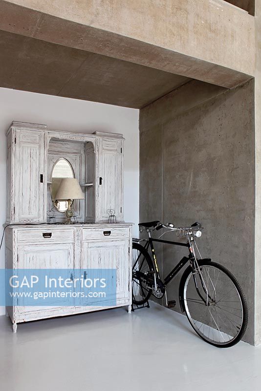 White antique cabinet with bicycle