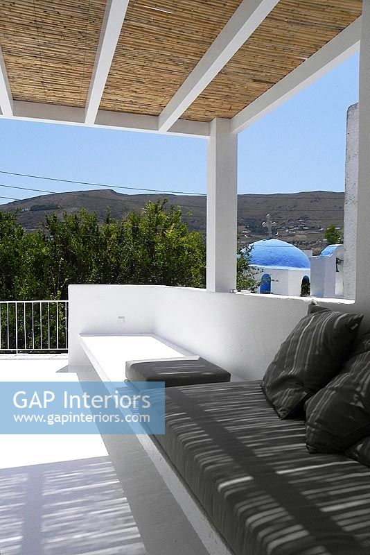 White roof terrace with view of Paros