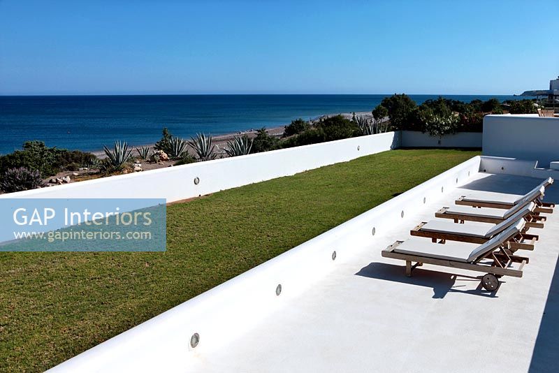 Loungers on terrace with sea view