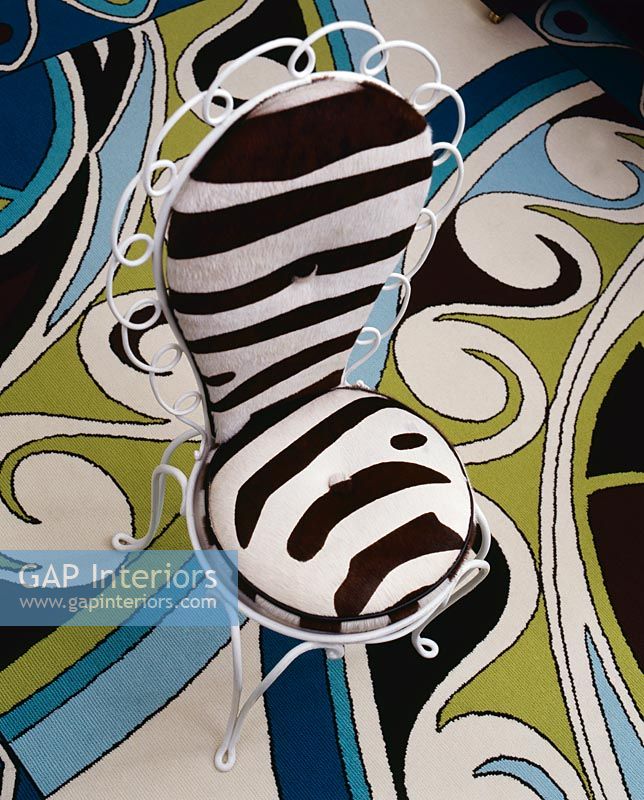 Zebra print armchair on patterned rug