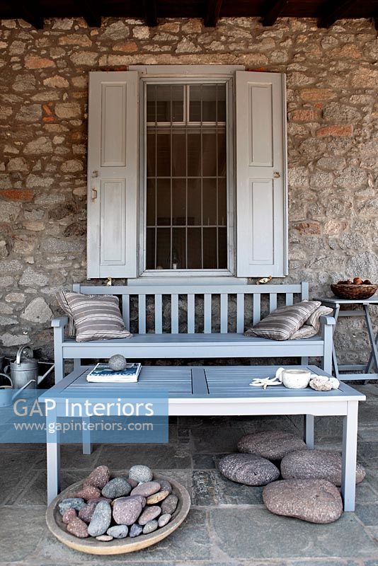 Stone patio with wooden furniture