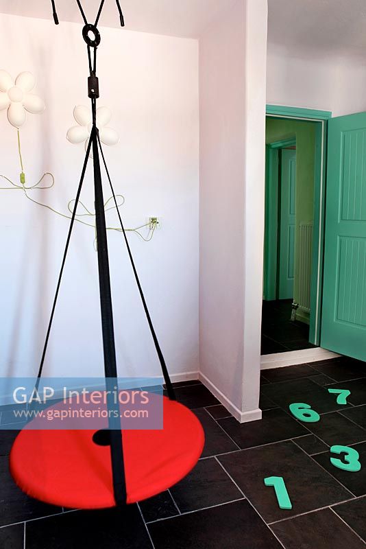 Red swing in childs room