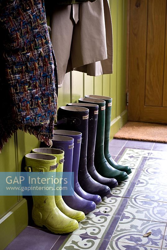 Row of wellies in hall
