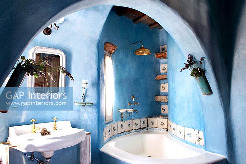 Blue bathroom with corner bath
