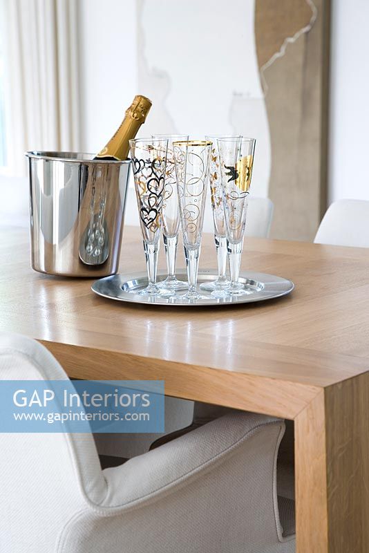 Champagne flutes on wooden table