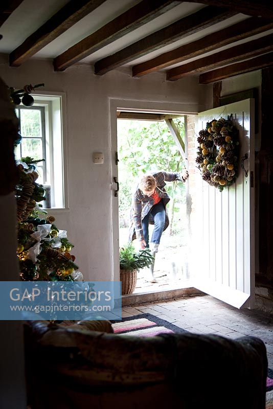 Nikki Tibbles at the entrance to her cottage at Christmas