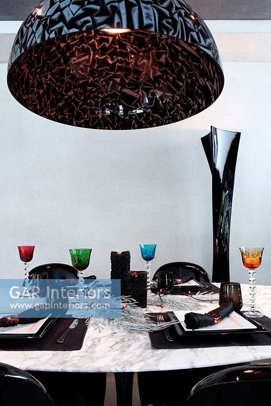 Modern pendant light above marble table
