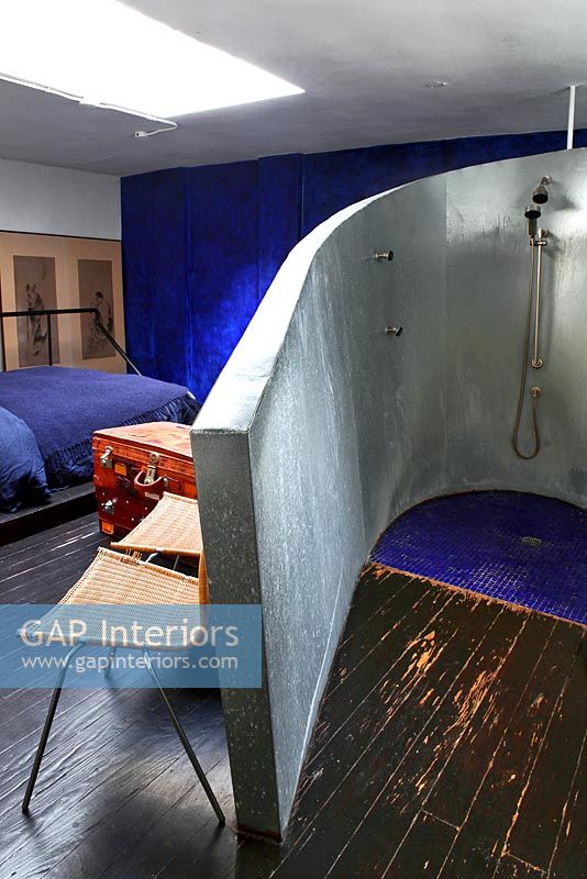 Industrial style open plan bedroom with en suite shower