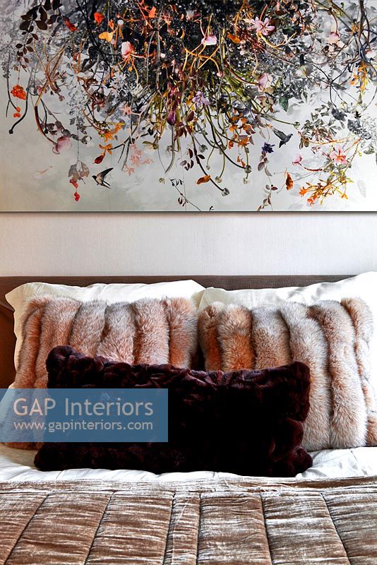 Contemporary bed with faux fur cushions