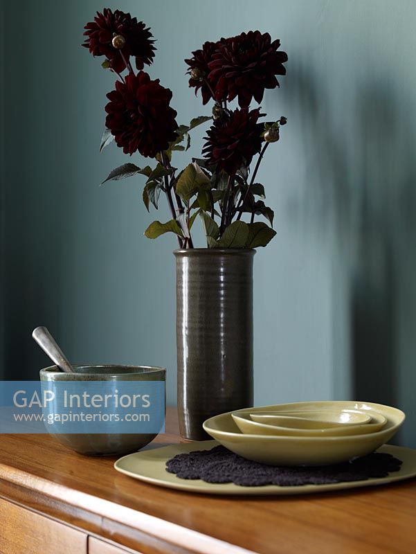 Maroon Dahlias and rustic pottery