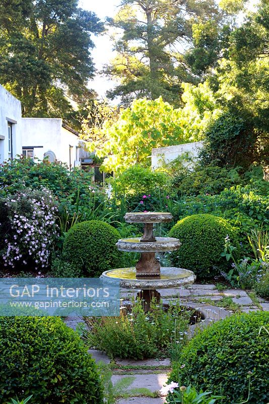 Cottage garden with water feature and Box topiary