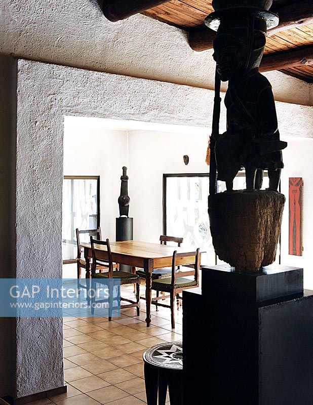 Dining room with tribal sculptures