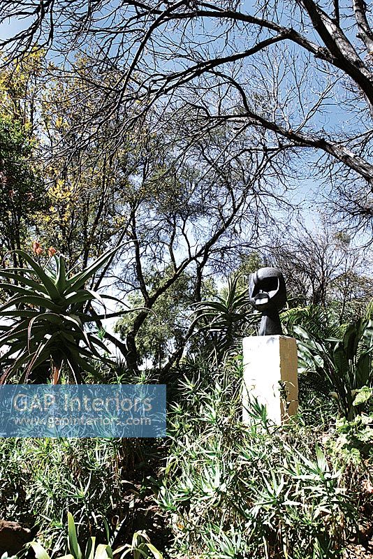 Modern sculpture in tropical garden